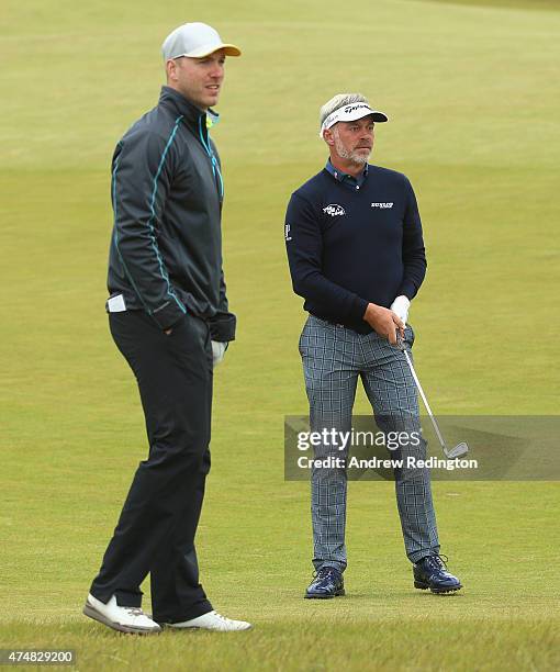 Rugby Player Stephen Ferris watches Darren Clarke of Northern Ireland during the Pro-Am round prior to the Irish Open at Royal County Down Golf Club...