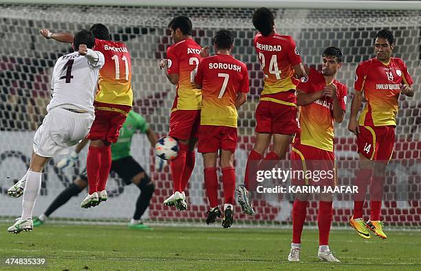 Qatar's Al-Jaish player Anderson Martins takes a free kick as Foolad Khouzestan players try to defend during their AFC Champions League group B...