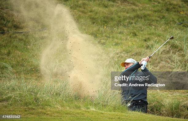 Rugby Player Stephen Ferris hits from a bunker during the Pro-Am round prior to the Irish Open at Royal County Down Golf Club on May 27, 2015 in...
