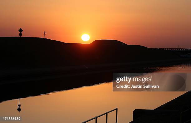 The sun rises over the Delta-Mendota Canal on February 25, 2014 in Los Banos, California. As the California drought continues and farmers struggle to...