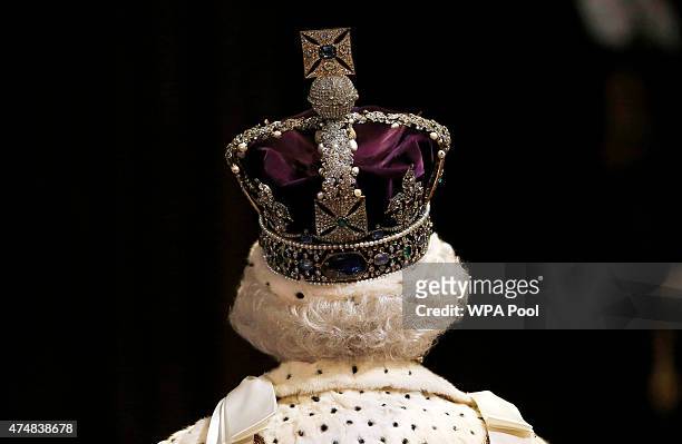 Queen Elizabeth II proceeds through the Royal Gallery before the State Opening of Parliament in the House of Lords at the Palace of Westminster on...