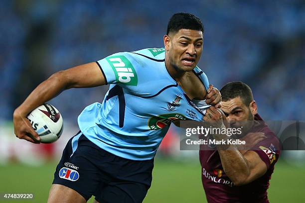 Daniel Tupou of the Blues is tackled by Greg Inglis of the Maroons during game one of the State of Origin series between the New South Wales Blues...