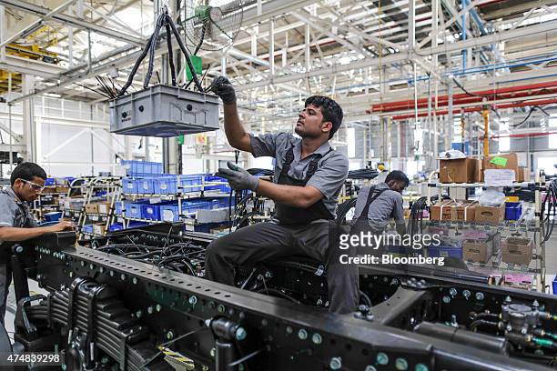 Employees wire the chassis of a BharatBenz truck on the production line of the Daimler India Commercial Vehicles Pvt. Manufacturing plant in Chennai,...