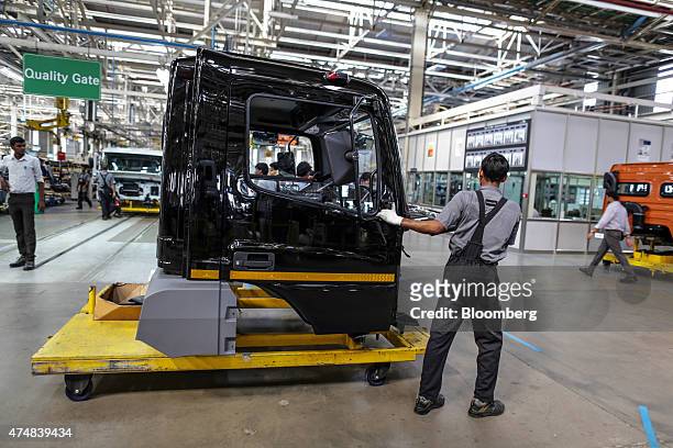 An employee transports the cabin of a BharatBenz truck on a cart on the production line of the Daimler India Commercial Vehicles Pvt. Manufacturing...