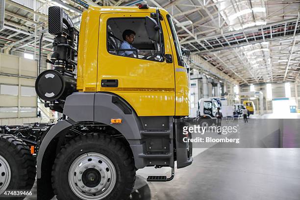 An employee examines the cabin of a BharatBenz truck on the production line of the Daimler India Commercial Vehicles Pvt. Manufacturing plant in...