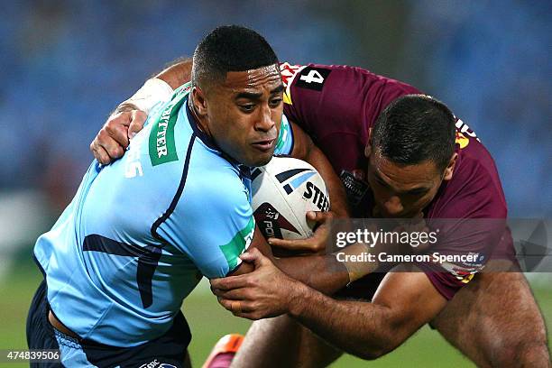 Michael Jennings of the Blues is tackled by Justin Hodges of the Maroons during game one of the State of Origin series between the New South Wales...