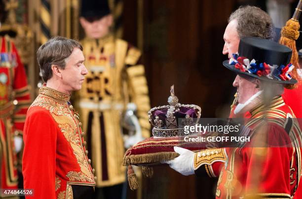 The Imperial State Crown is presented to Lord Great Chamberlain David Cholmondeley, Marquess of Cholmondeley, in the Royal Gallery during the State...