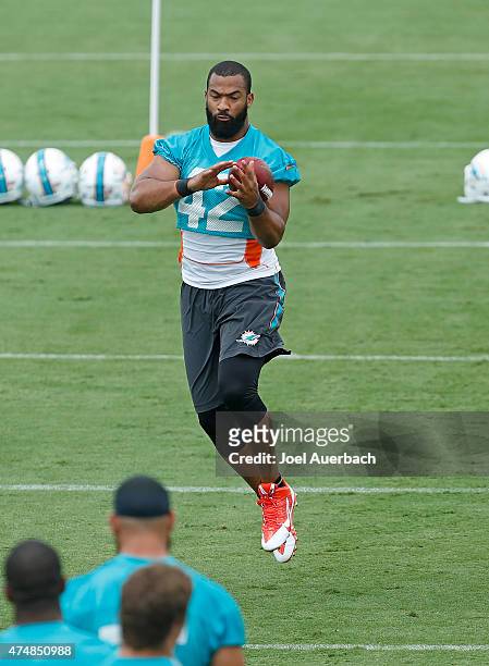 Spencer Paysinger of the Miami Dolphins catches the ball during the teams first OTA's on May 26, 2015 at the Miami Dolphins training facility in...
