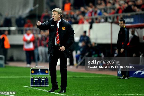 Manchester United's Scottish manager David Moyes gestures during the round of 16 Champions League football match Olympiakos vs Manchester United at...