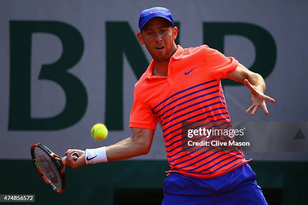 Dudi Sela of Israel plays a forehand in his Men's Singles match against Jo-Wilfried Tsonga of France during day four of the 2015 French Open at...