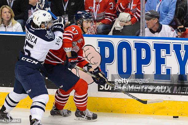 Anthony Deluca of the Rimouski Oceanic challenges Stephen Desrocher of the Oshawa Generals as he moves the puck in Game Two during the 2015 Memorial...