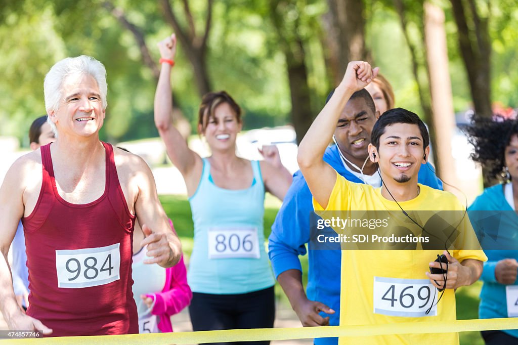 Young Hispanic man celebrating finishing marathon race