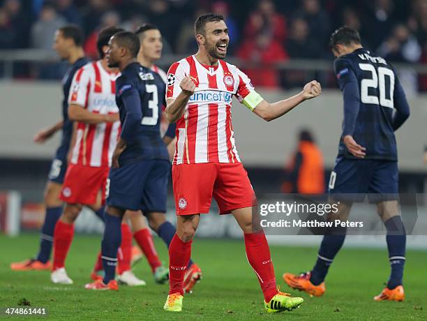 Giannis Maniatis of Olympiacos FC celebrates at the final whistle during the UEFA Champions League Round of 16 match between Olympiacos FC and...