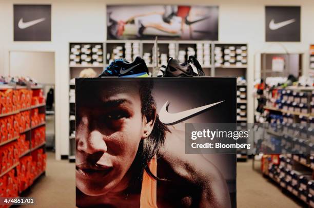 An advertisement for Nike Inc. Is displayed in the shoe department of a J.C. Penney Co. Store at the Collin Creek Mall in Plano, Texas, U.S., on...
