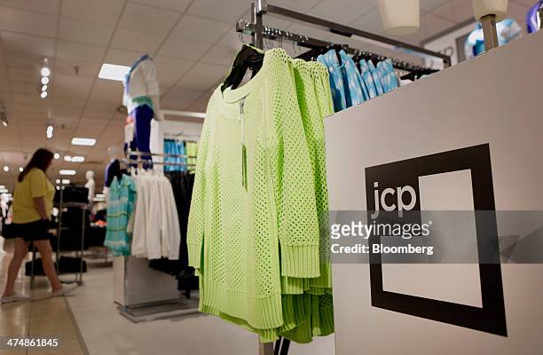 The J.C. Penney Co. Logo is displayed next to clothing for sale inside the company's store at the Collin Creek Mall in Plano, Texas, U.S., on Sunday,...
