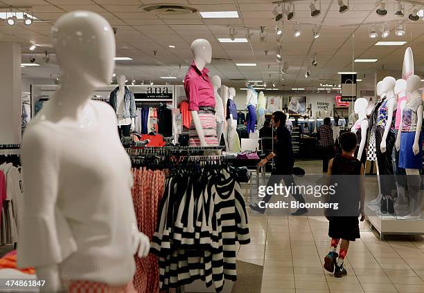 Shoppers walk past mannequins displayed in the women's department of a J.C. Penney Co. Store at the Collin Creek Mall in Plano, Texas, U.S., on...