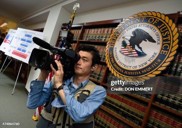 Cameraman does some video before the announcement of charges against FIFA officials at a news conference on May 27, 2015 in New York. The soccer...