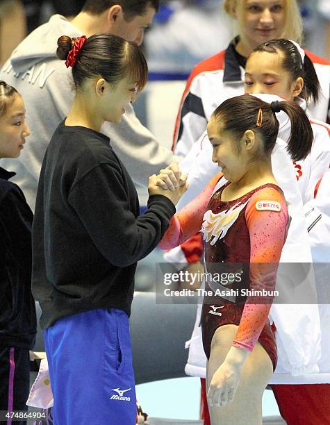 Winner Koko Tsurumi and second place Rie Tanaka shake hands after day two of the All Japan Artistic Gymnastics Championships at Yoyogi National...