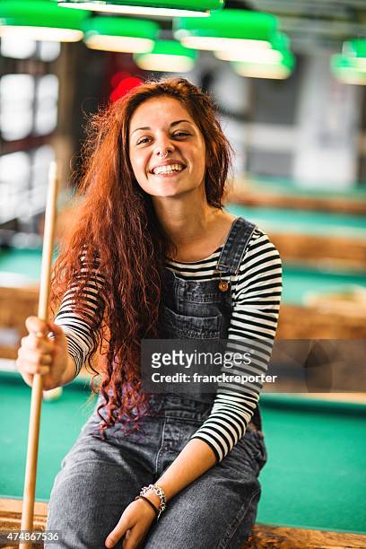 happiness girl standing in a pub at the pool table - cosy pub stock pictures, royalty-free photos & images
