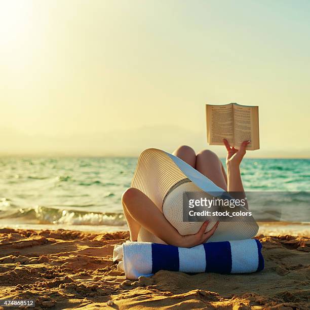 so relax when reading - woman on beach reading stock pictures, royalty-free photos & images
