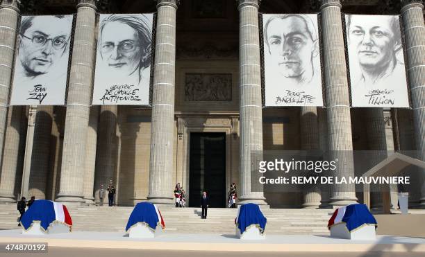 French President Francois Hollande stands in front of the Pantheon where four flag-draped caskets representing World War II Resistance fighters...