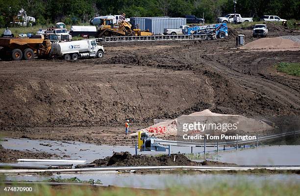 Workers tend to equipment used to pump water from Padera Lake on May 27, 2015 in Midlothian, Texas. Officials feared that the temporary dam on Padera...