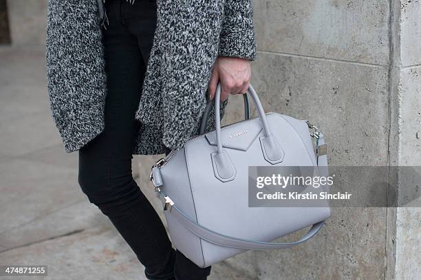 Model Milana Kruz wears a Givenchy bag, Rag and Bone sweater, Zadig and Voltaire coat, H and M jeans on day 1 of Paris Collections: Women on February...
