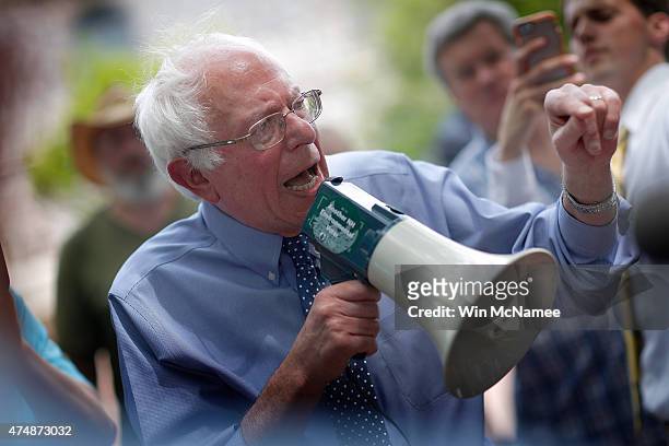 Democratic presidential candidate and U.S. Sen. Bernie Sanders speaks to an overflow crowd through a megaphone after a campaign event at the New...