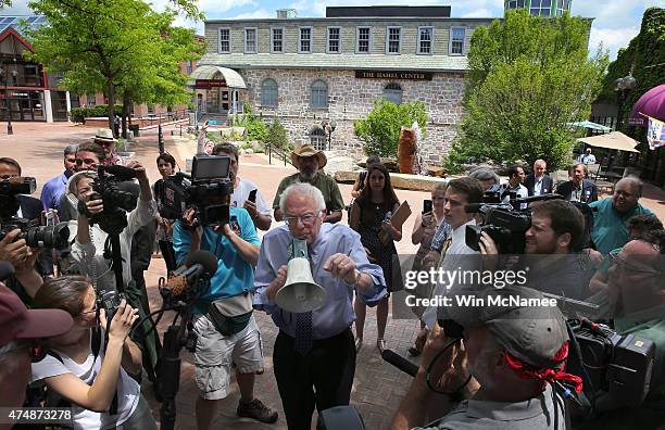 Democratic presidential candidate and U.S. Sen. Bernie Sanders speaks to an overflow crowd through a megaphone after a campaign event at the New...