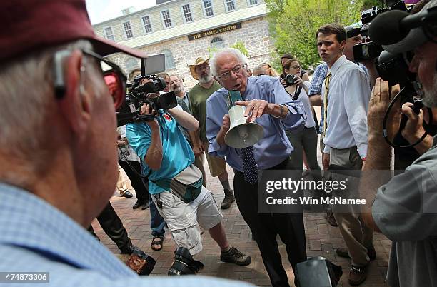 Democratic presidential candidate and U.S. Sen. Bernie Sanders speaks to an overflow crowd through a megaphone after a campaign event at the New...