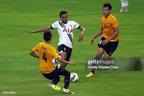 Grant Ward of Tottenham Hotspur battles with Mohd Nasir and Muslim Ahmad of Malaysia XI during the pre-season friendly match between Malaysia XI and...