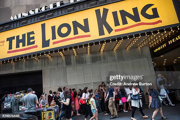 People wait in line to see the matinee show of The Lion King on May 27, 2015 in New York City. The Broadway season broke records with 13.1 million...