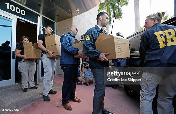 Agents carry boxes from the headquarters of CONCACAF after it was raided on May 27, 2015 in Miami Beach, Florida. The raid is part of an...