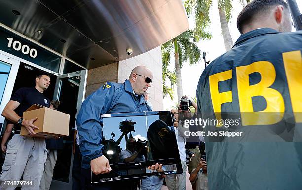 Agents carry boxes and computers from the headquarters of CONCACAF after it was raided on May 27, 2015 in Miami Beach, Florida. The raid is part of...