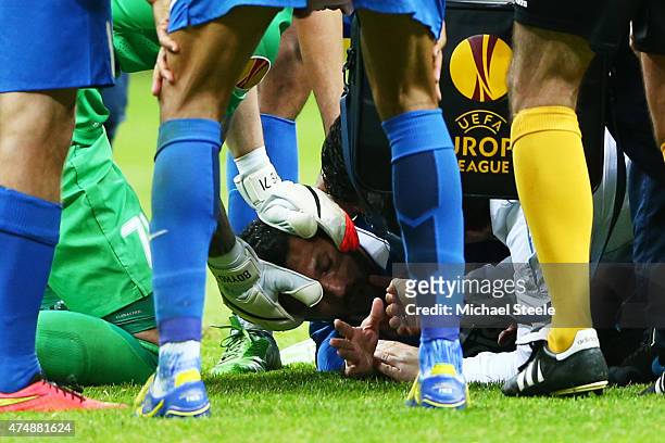 Matheus of Dnipro receives treatment from team mates during the UEFA Europa League Final match between FC Dnipro Dnipropetrovsk and FC Sevilla on May...