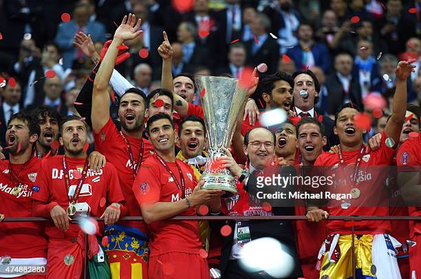 Jose Antonio Reyes of Sevilla and Sevilla President Jose Castro hold the trophy as they celebrate victory after the UEFA Europa League Final match...