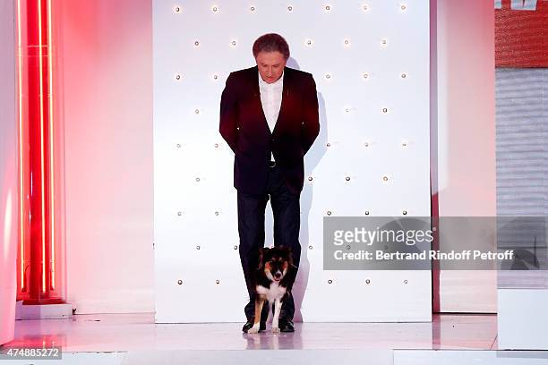 Presenter of the show Michel drucker and his dog Isia attend the 'Vivement Dimanche' French TV Show at Pavillon Gabriel on May 27, 2015 in Paris,...