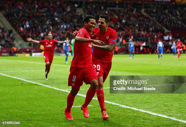 Carlos Bacca of Sevilla celebrates scoring his team's third goal with Vitolo of Sevilla during the UEFA Europa League Final match between FC Dnipro...