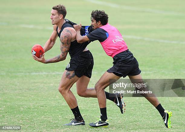 Jesse White handballs during a Collingwood Magpies AFL training session at the Southport Football Club on February 26, 2014 on the Gold Coast,...