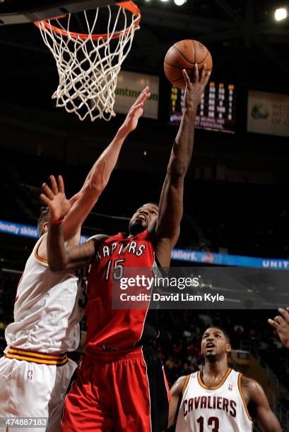 Amir Johnson of the Toronto Raptors goes up for the shot against Spencer Hawes of the Cleveland Cavaliers at The Quicken Loans Arena on February 25,...