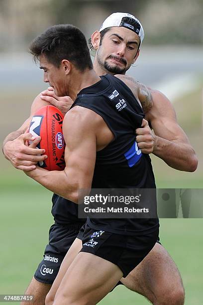 Brodie Grundy tackles Marley Williams during a Collingwood Magpies AFL training session at the Southport Football Club on February 26, 2014 on the...