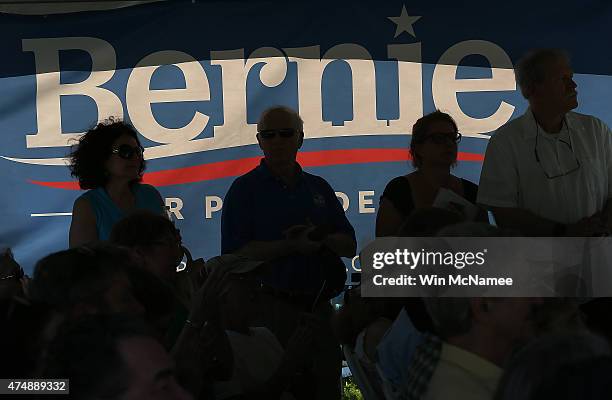 Supporters listen as Democratic presidential candidate and U.S. Sen. Bernie Sanders speaks to supporters at a house party campaign event at the home...