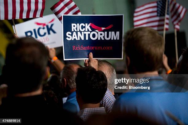 Supporters hold up signs as Rick Santorum, former U.S. Senator of Pennsylvania, not pictured, speaks while announcing he will seek the Republican...