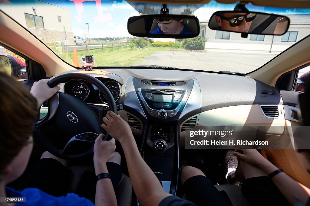Blind people get a chance to drive cars and feel what it is like to be behind the wheel of a car at The MasterDrive Experience in Centennial, Colorado.
