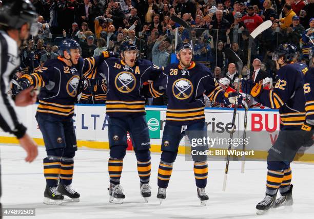 Christian Ehrhoff of the Buffalo Sabres celebrates his game-winning goal with teammates Alexander Sulzer, Zemgus Girgensons and Marcus Foligno in...