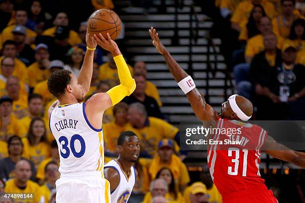 Stephen Curry of the Golden State Warriors shoots the ball against Jason Terry of the Houston Rockets in the first half during game five of the...