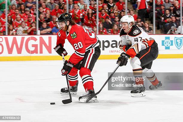 Brandon Saad of the Chicago Blackhawks handles the puck ahead of Hampus Lindholm of the Anaheim Ducks, resulting in a goal in the second period, in...