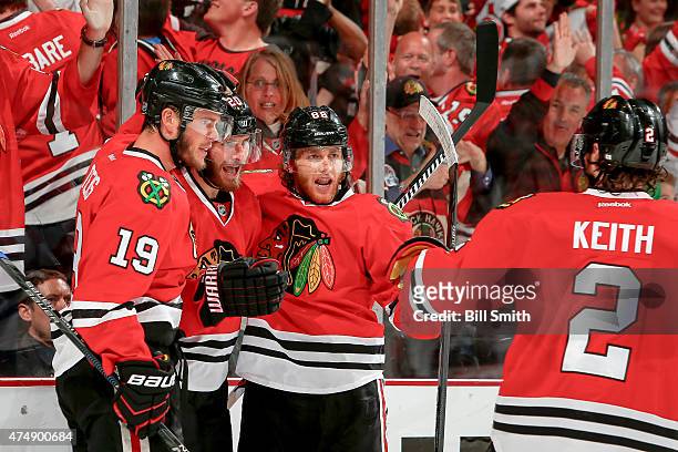 Brandon Saad of the Chicago Blackhawks celebrates with Patrick Kane and Jonathan Toews after scoring in the second period against the Anaheim Ducks...