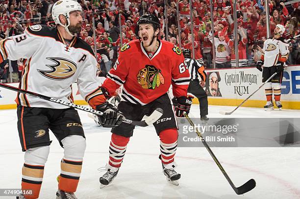 Andrew Shaw of the Chicago Blackhawks reacts next to Francois Beauchemin of the Anaheim Ducks after scoring in the third period in Game Six of the...