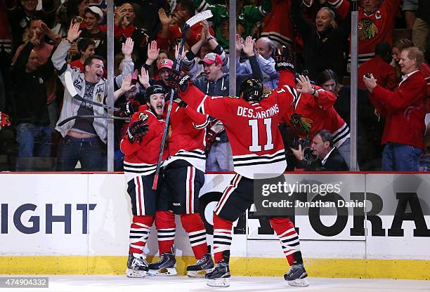 Andrew Shaw of the Chicago Blackhawks celebrates with teammates after scoring a third period goal against the Anaheim Ducks in Game Six of the...